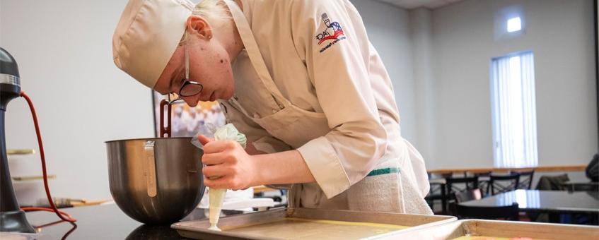 A student using a piping bag.